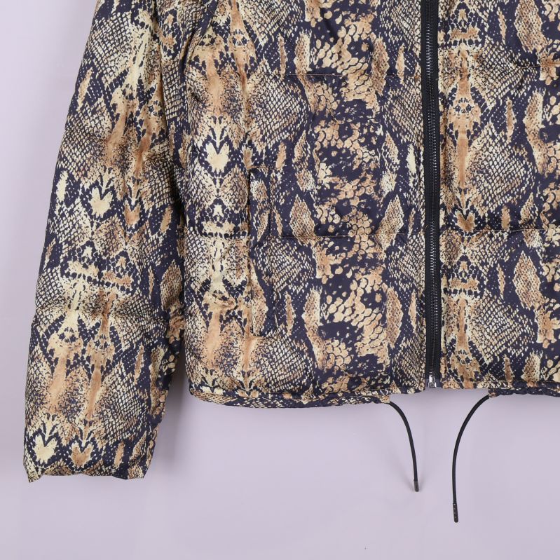 Nedre del av jacka med dragsko och ormmönstrad yta