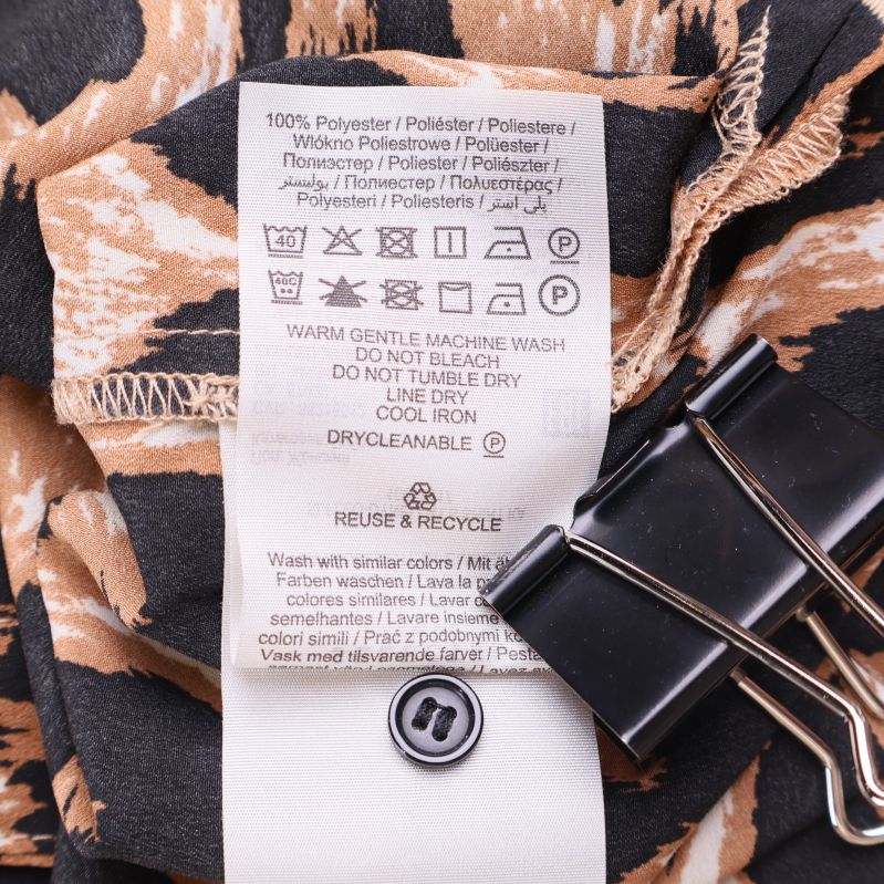 Tvättråds- och materialetikett visar 100 procent polyester