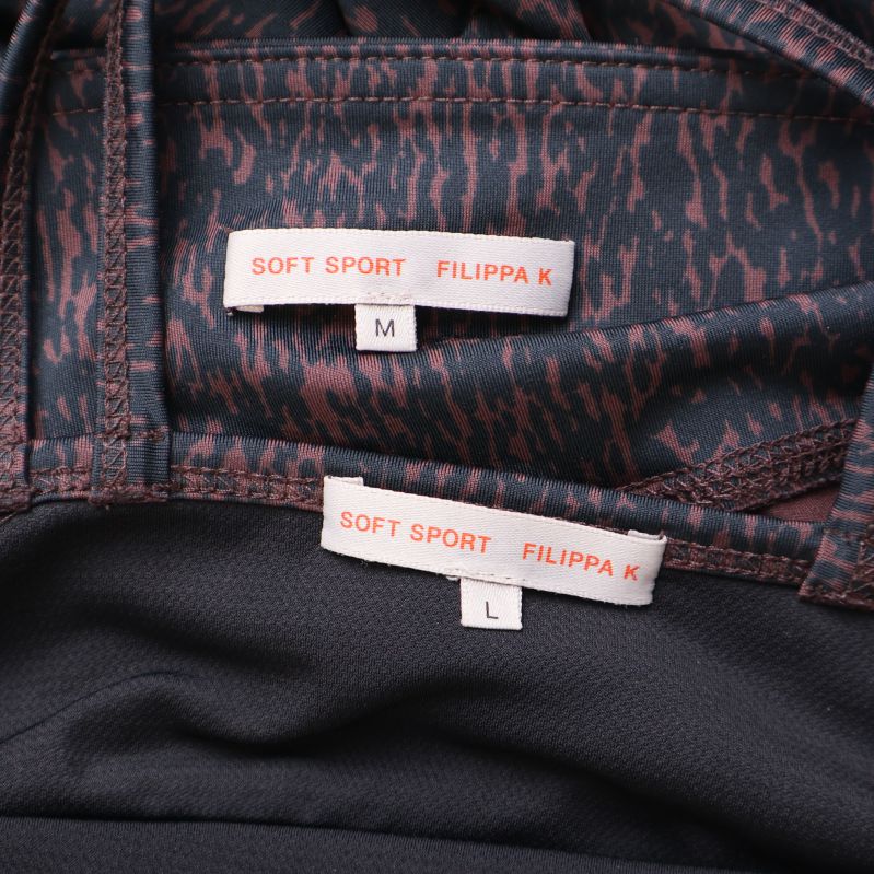 Närbild på etiketter med Filippa K Soft Sport och storlekar M och L