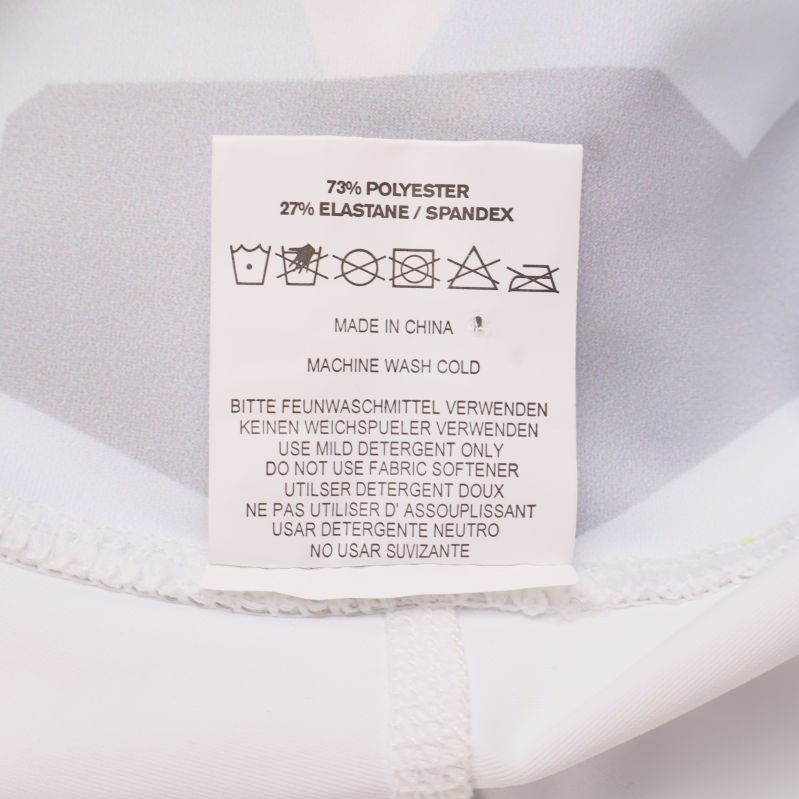 Tvättrådslapp med materialinformation 73% polyester 27% elastan