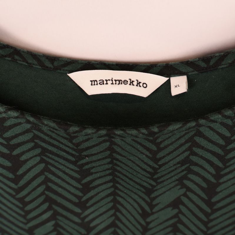 Närbild på Marimekko etikett och storlekslapp XL i halsen