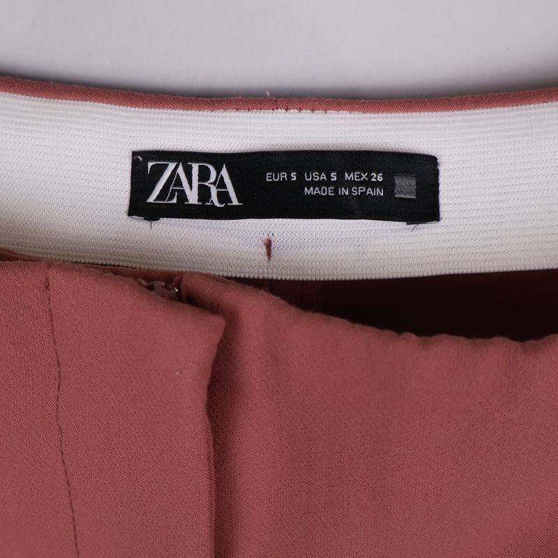 Närbild på ZARA etikett i midjan på byxorna