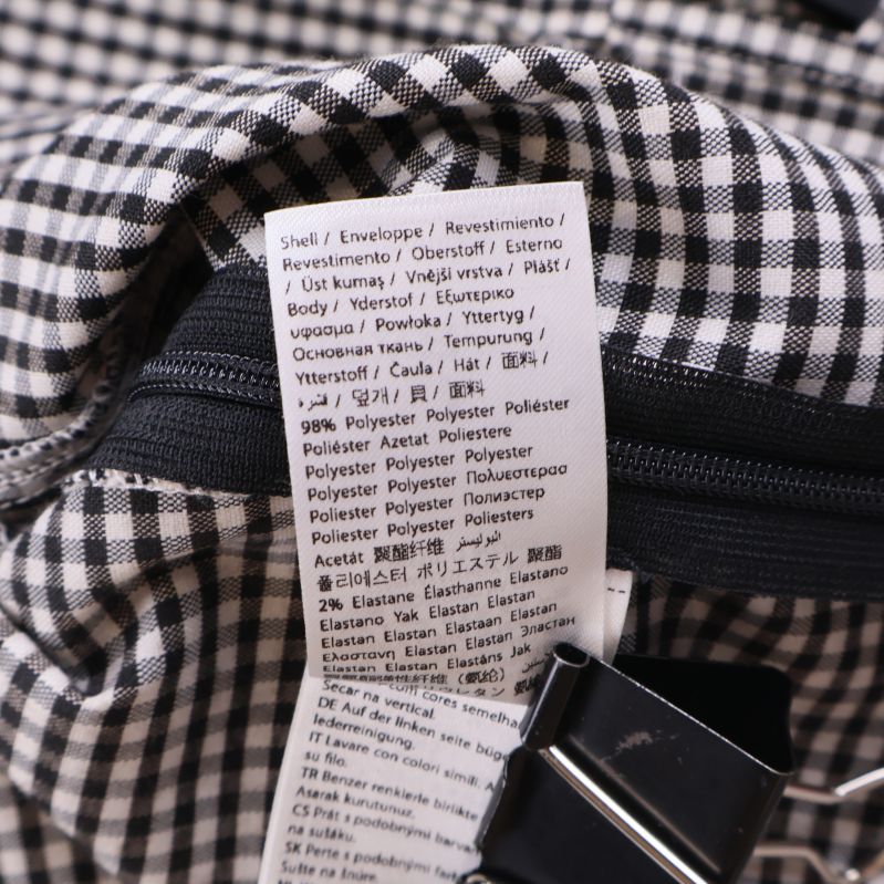 Materialetikett som visar polyester och elastan