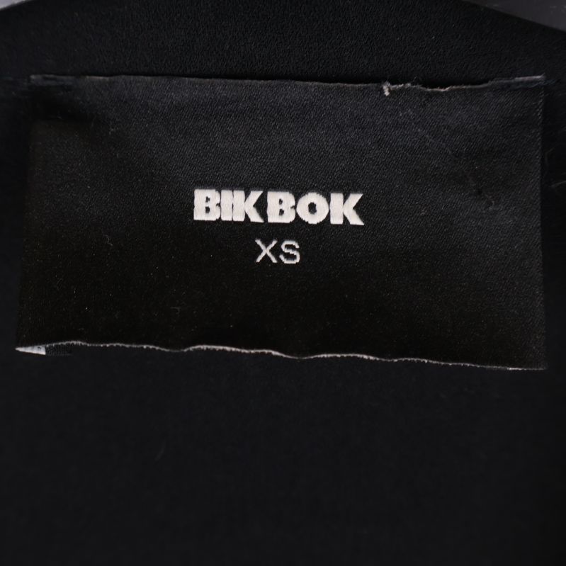 Närbild på Bik Bok-etikett i kappans nacke med storlek XS