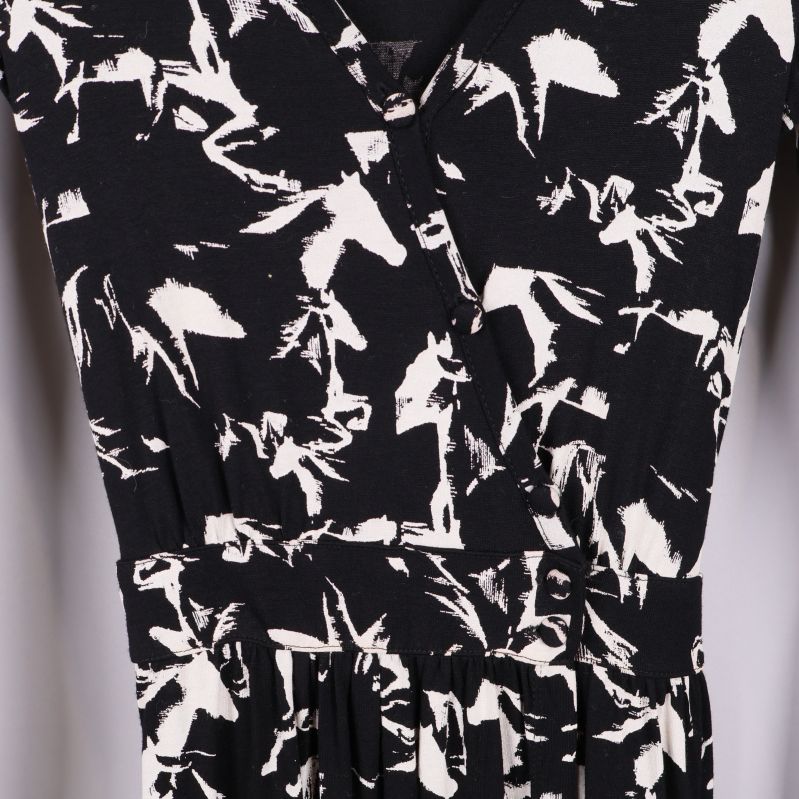 Närbild på midja och mönster av svartvit klänning