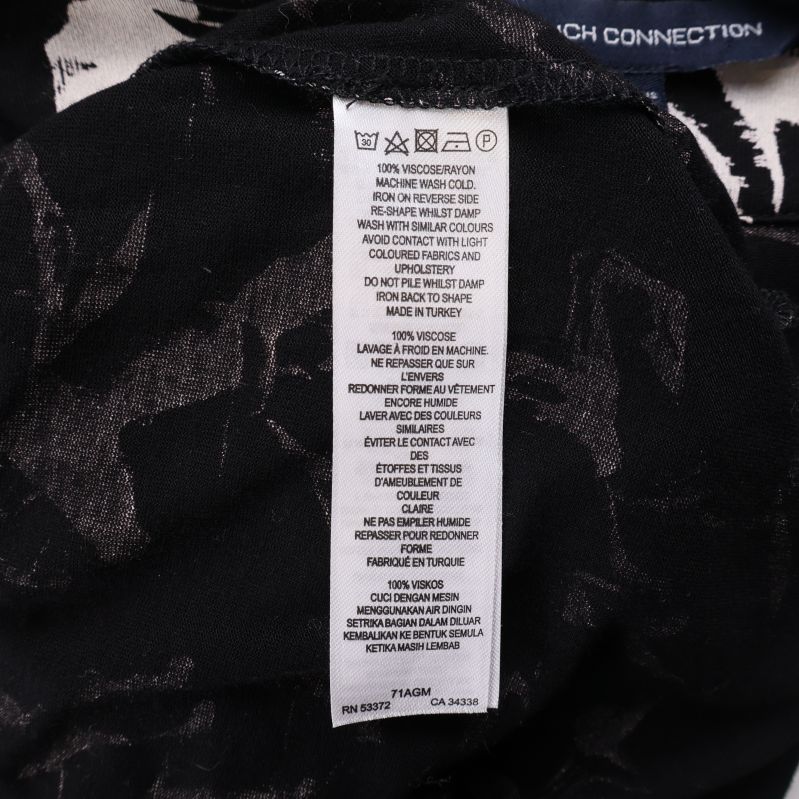 Materiallapp med tvättsymboler och materialinformation på insidan