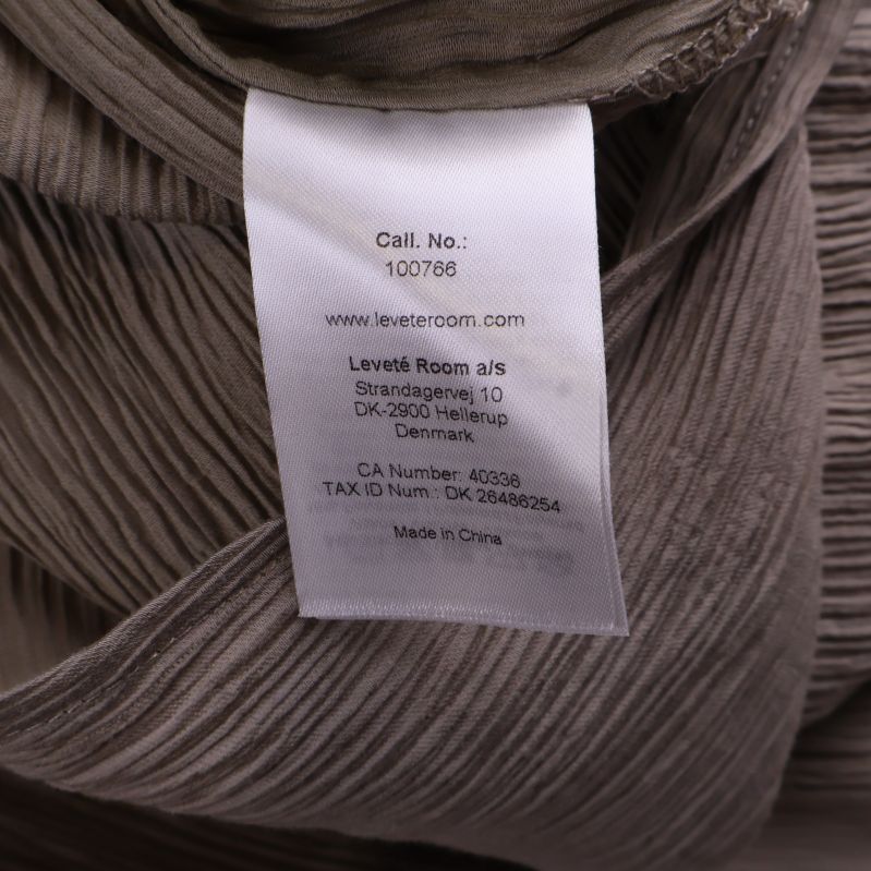 Sidsöm med vit tillverkningsetikett inuti klänningen