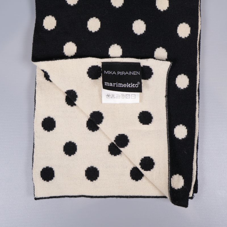 Närbild på dubbelsidig stickad prickig halsduk