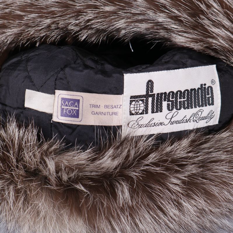 Närbild på mössans innertyg och märke Furscandia Saga Fox