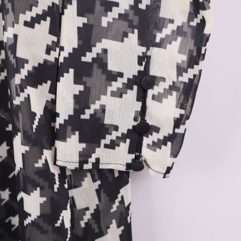 Närbild på ärmslut med knappar på klänning