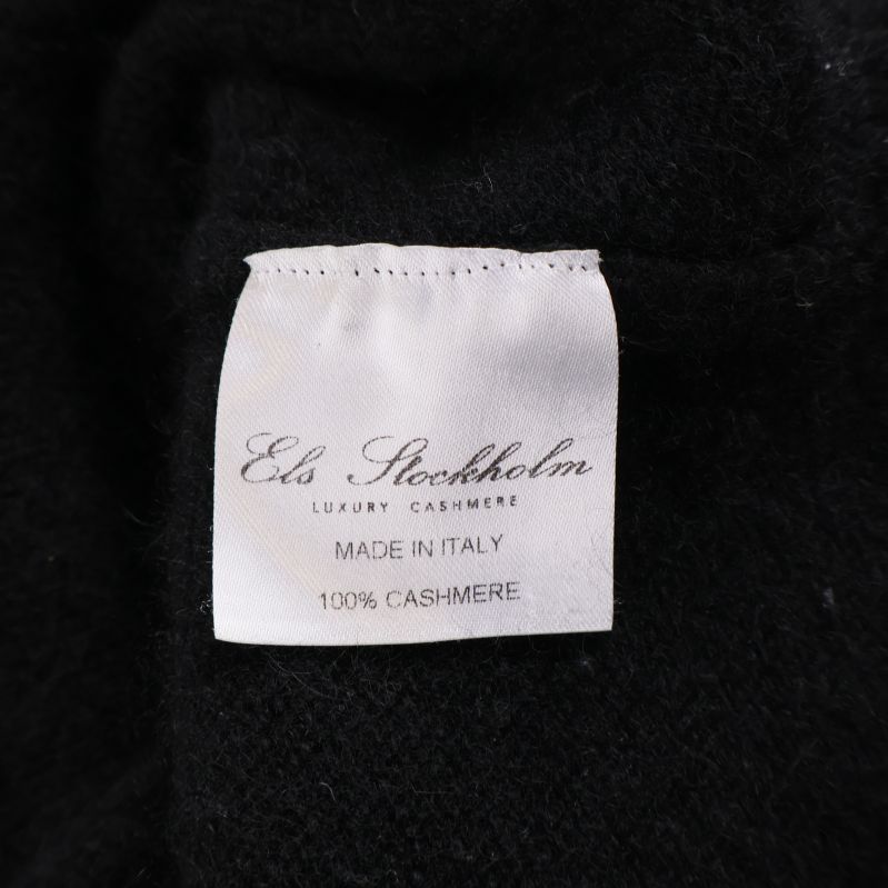 Vitt märke med texten ELS Stockholm Luxury Cashmere 100% Cashmere
