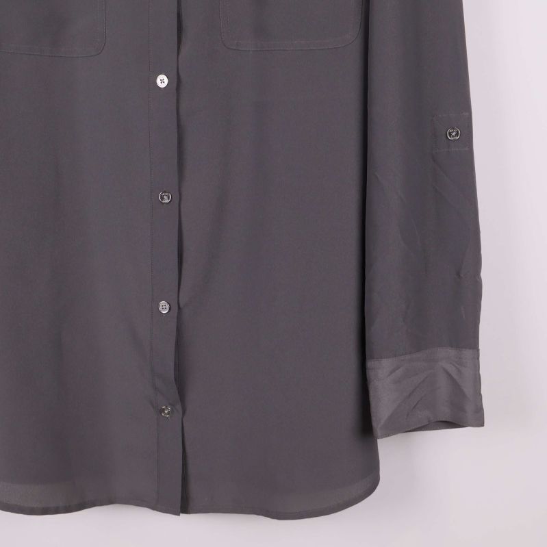 Nedre delen av skjorta visar manschett och knappar