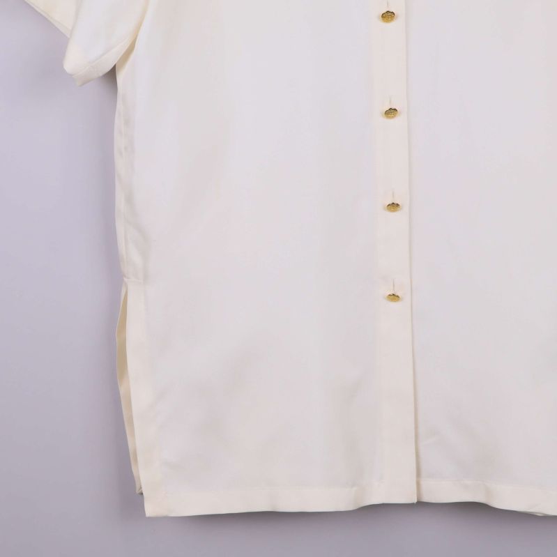Nedre del av vit skjorta med sidslits och knappslå
