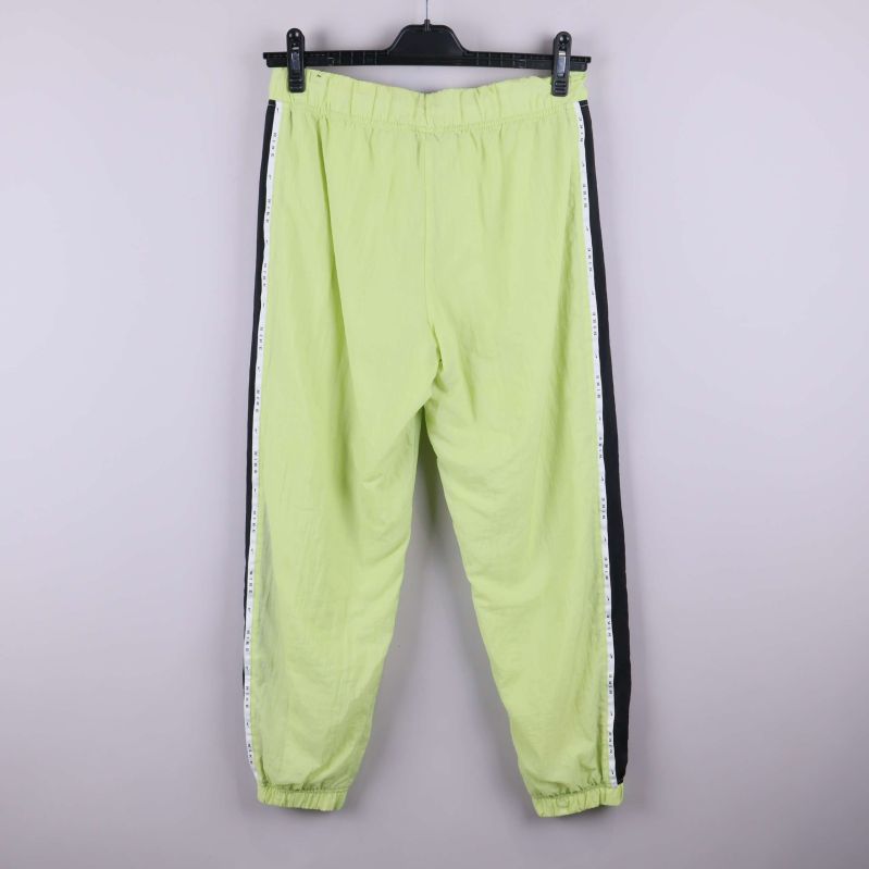 Baksida av ljusgrön träningsbyxa med svarta paneler