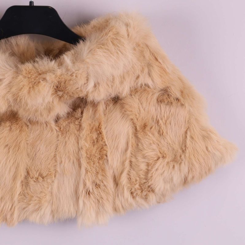 Höger sida av beige pälsponcho med mjuk päls