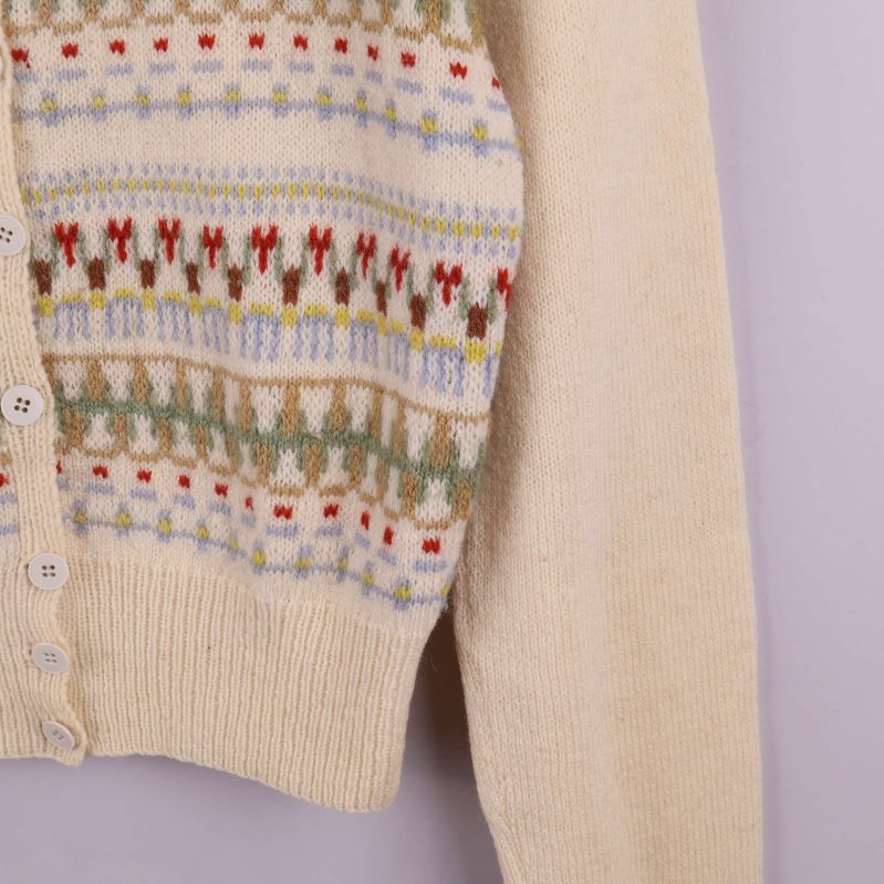 Närbild av baksida och ärm på ljus kofta