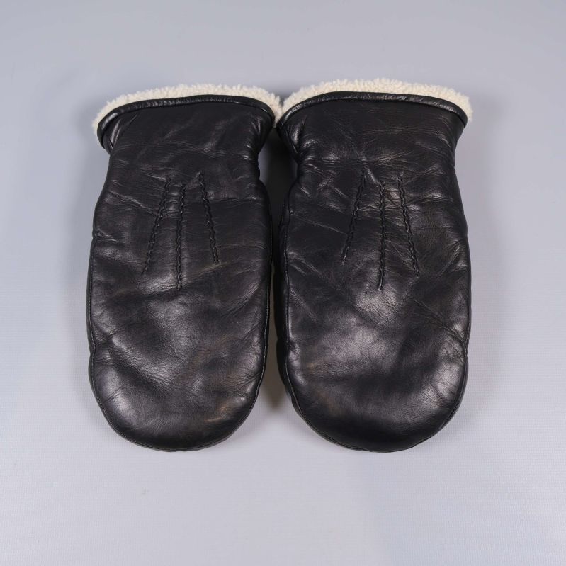 Svarta tumvantar i skinn liggande sida vid sida