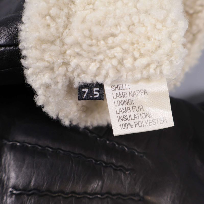 Närbild på etikett som visar material och storlek 7.5