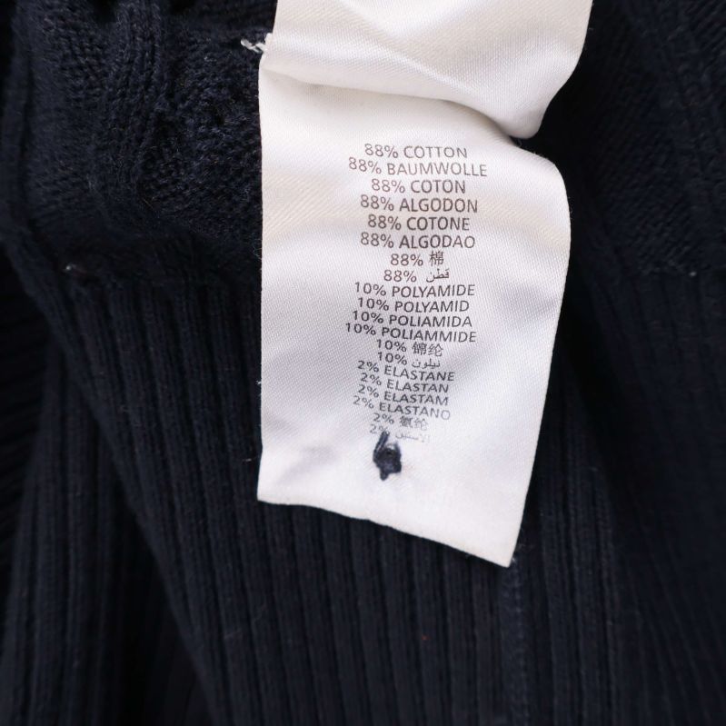 Materialetikett som visar 88% bomull, 10% polyamid, 2% elastan