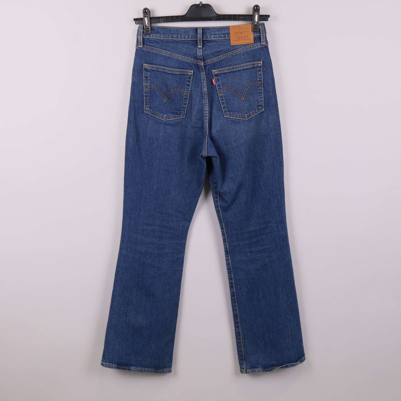 Blå jeans bakifrån med tydliga bakfickor och etikett