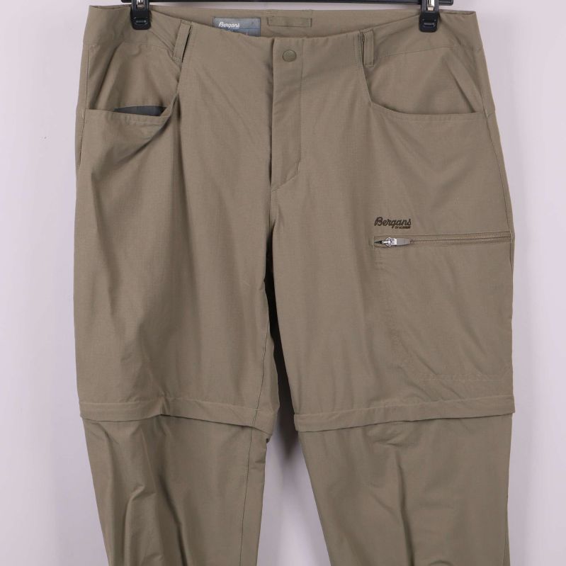 Detaljbild på fickor och stängning på friluftsbyxor