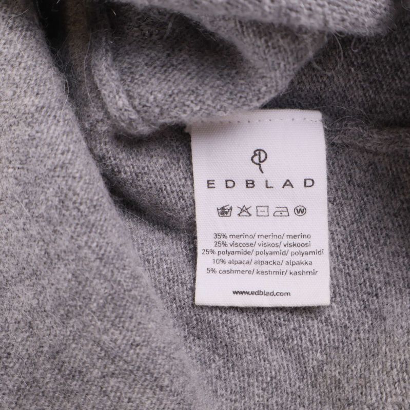 Materiallapp med materialfördelning i procent och tvättråd