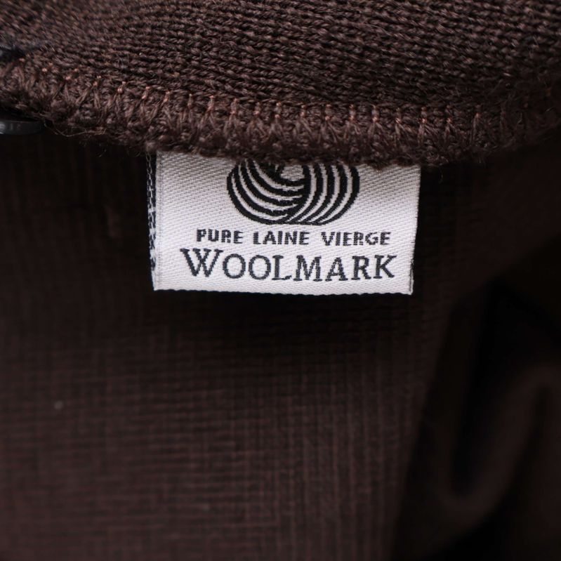 Materialmärkning med Woolmark och texten Pure Laine Vierge