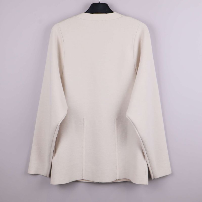 Beige cardigan med lång ärm fotad bakifrån på galge