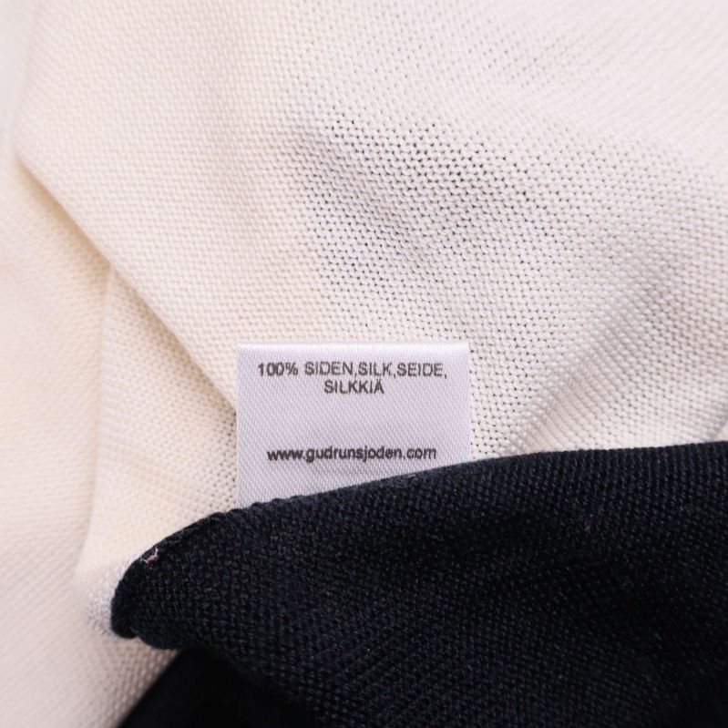 Materialetikett med texten 100% siden flera språk