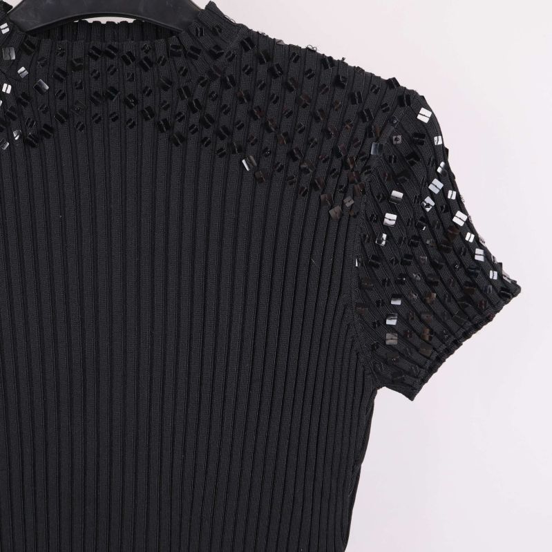 Ärmdetalj med svarta paljetter på ribbad topp