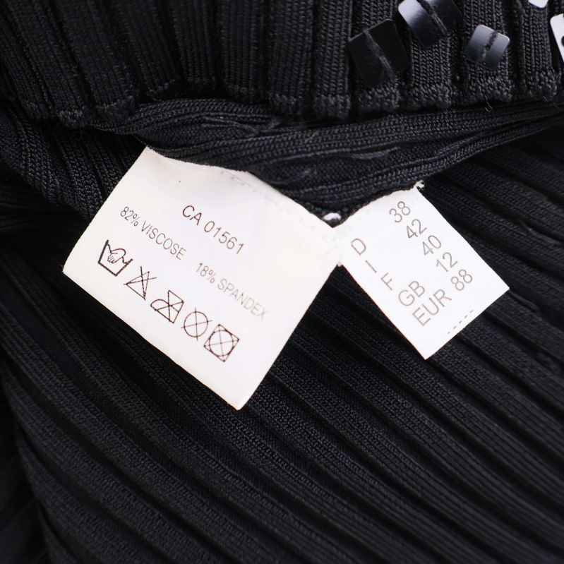 Material- och storleksetikett: 85% viskos, 15% spandex