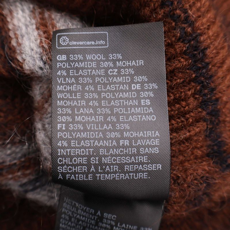 Materialetikett visar ull, polyamid, mohair och elastan