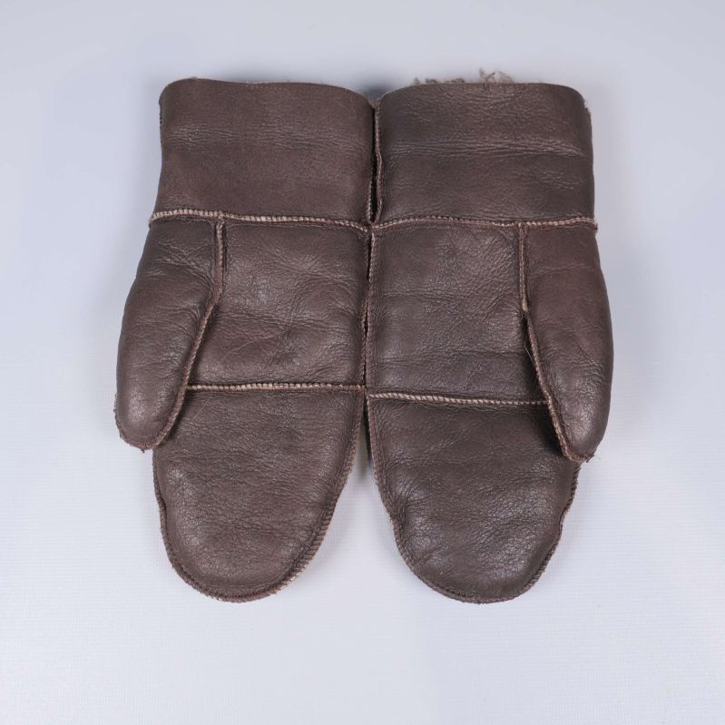 Två bruna vintervantar med tummen utåt på båda