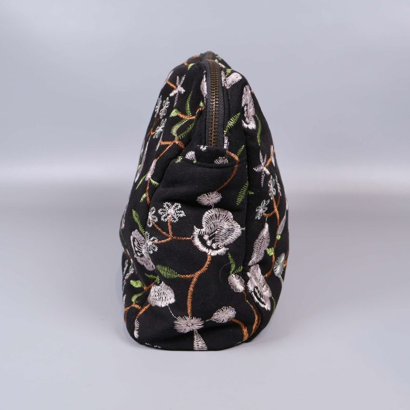 Necessär i profil där formen och broderierna syns tydligt