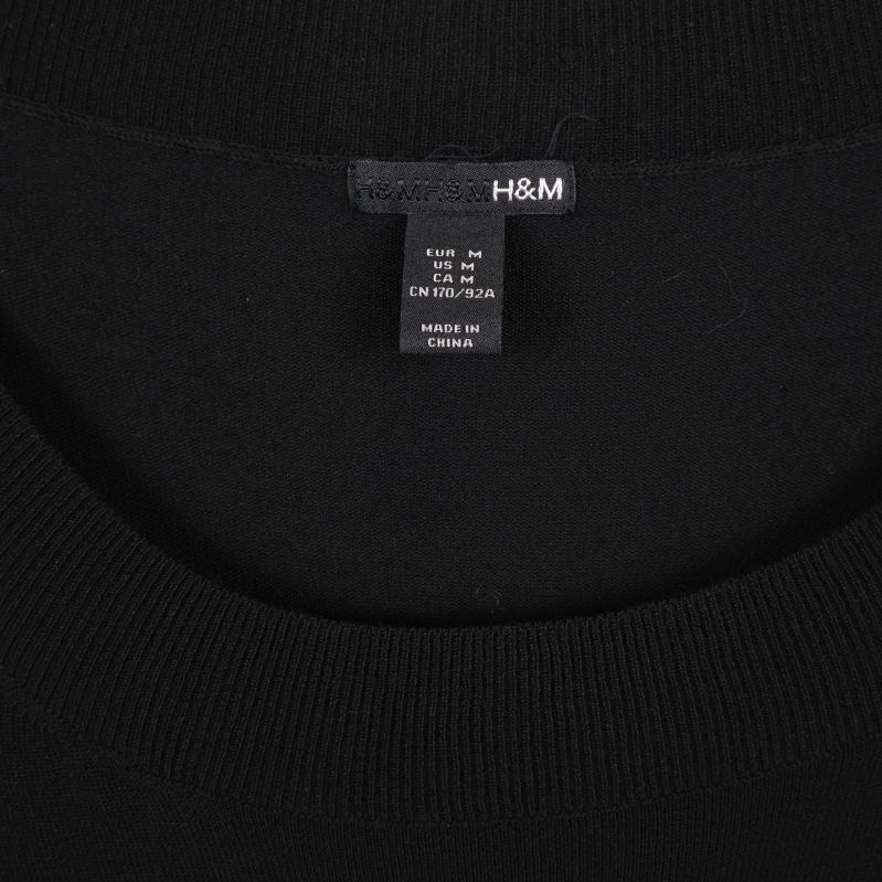 H&M logotyp på inneretikett