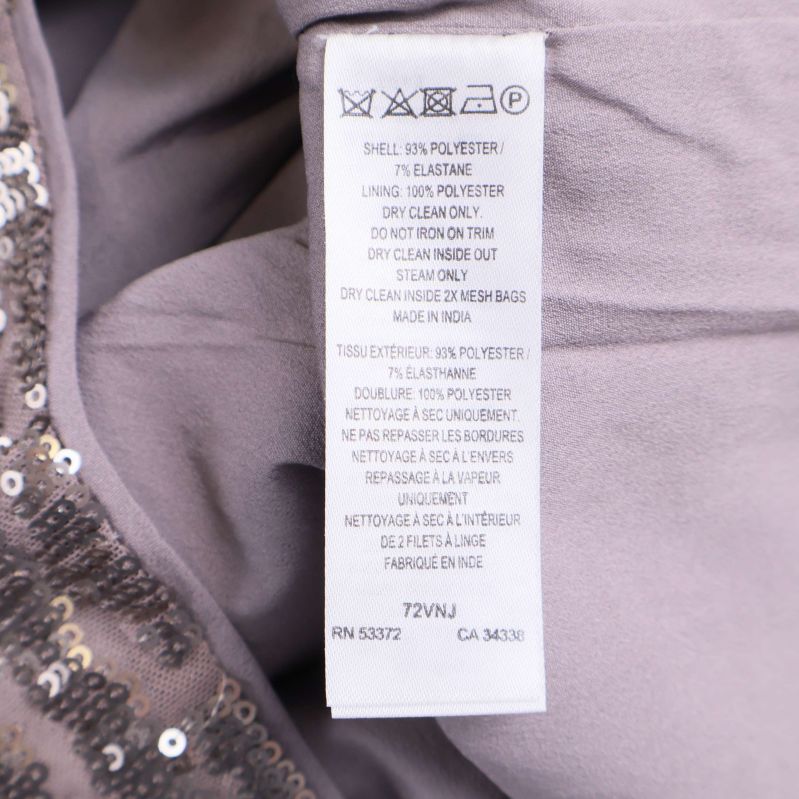 Tvättlapp med information om material och skötselråd i paljettopp