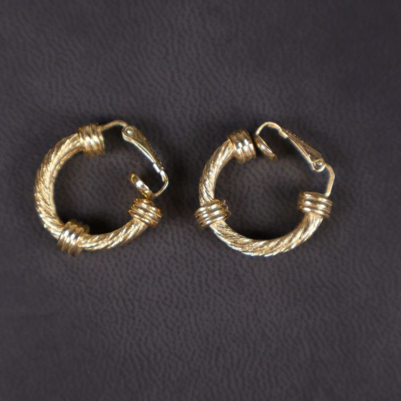 Två guldfärgade runda örhängen med tvinnad yta