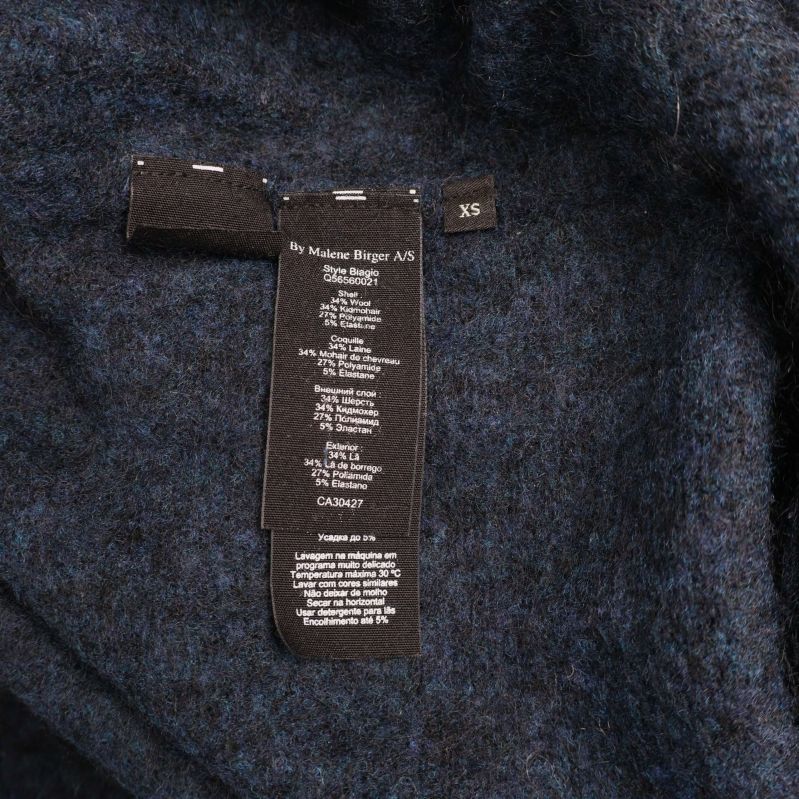 Materiallapp med tvättråd och storleksinformation XS