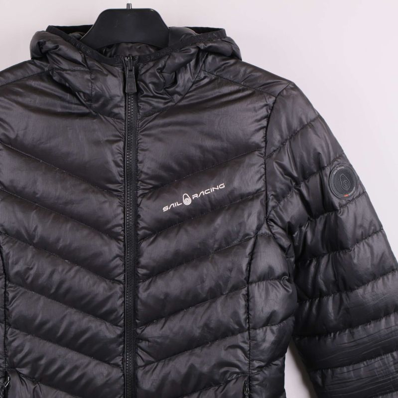 Närbild på vänster bröst med Sail Racing-logga