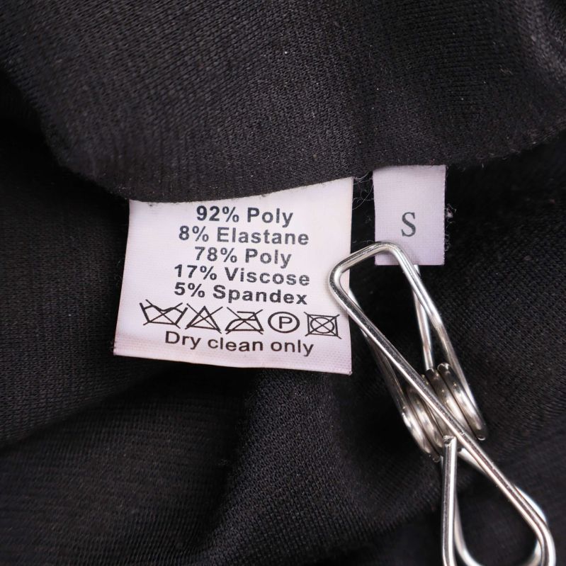 Materiallapp med information om polyester, elastan, viskos och spandex