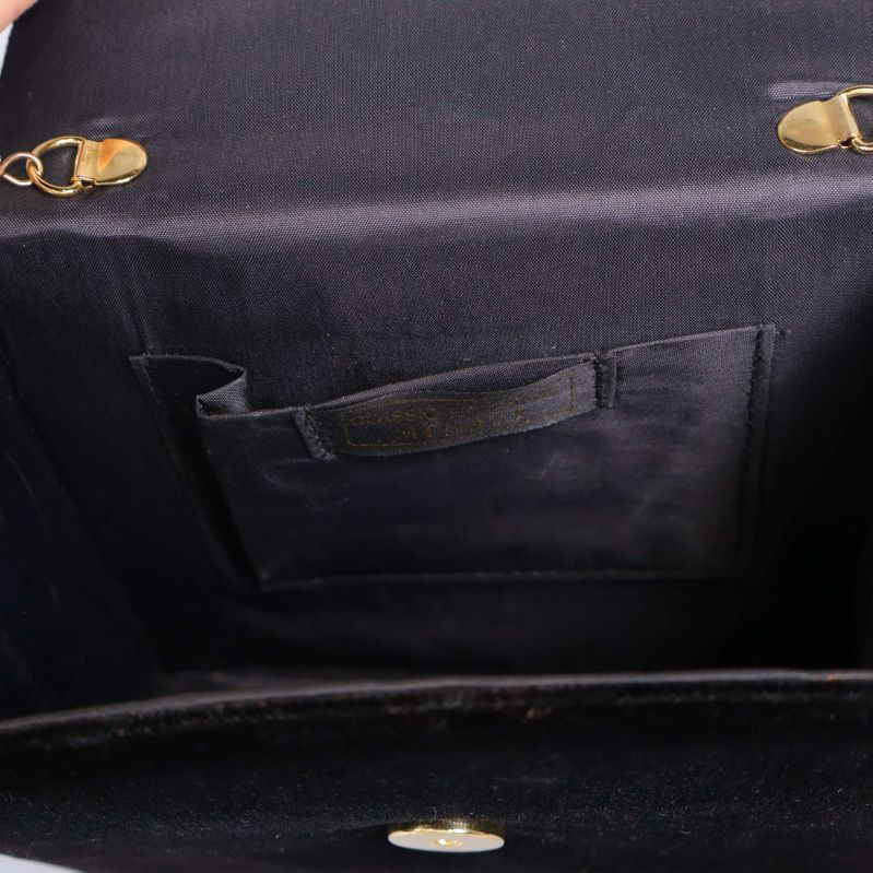 Insidan av svart aftonväska med innerficka och knäpplås