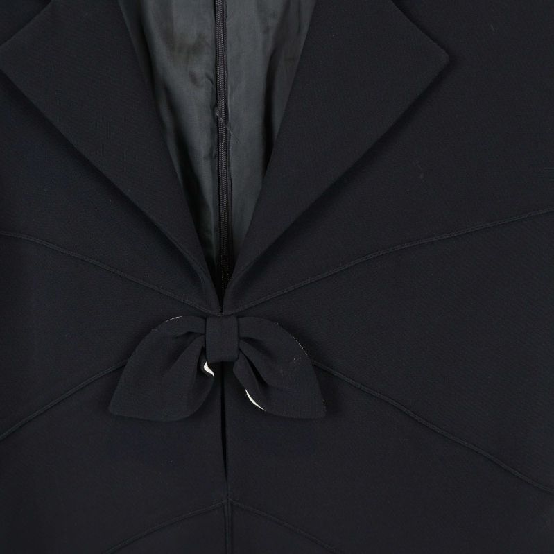 Närbild på rosettdetalj och krage framtill