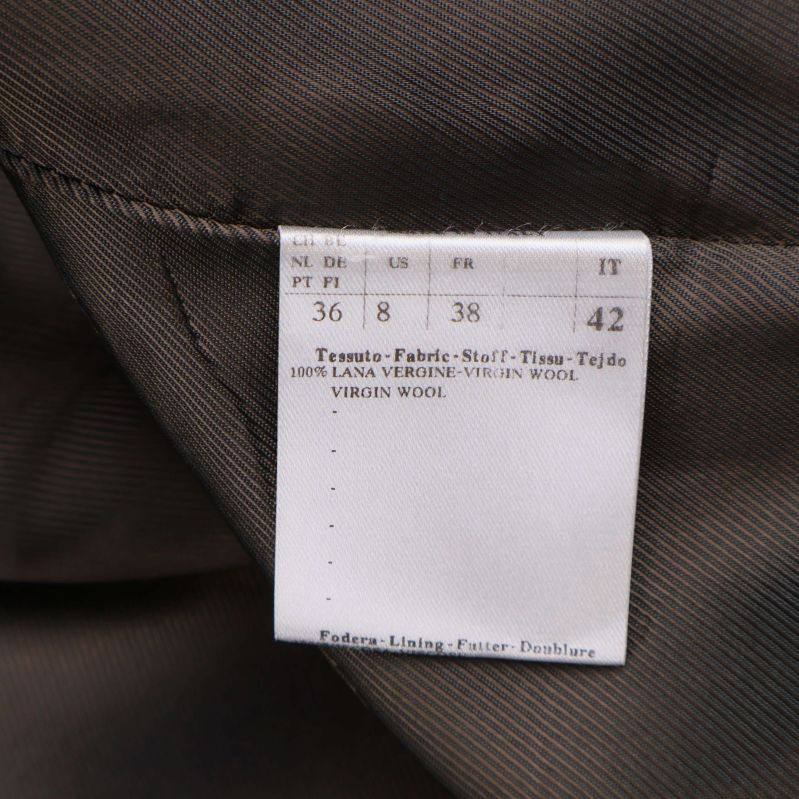 Materiallapp som visar 100% ull och storleksinformation