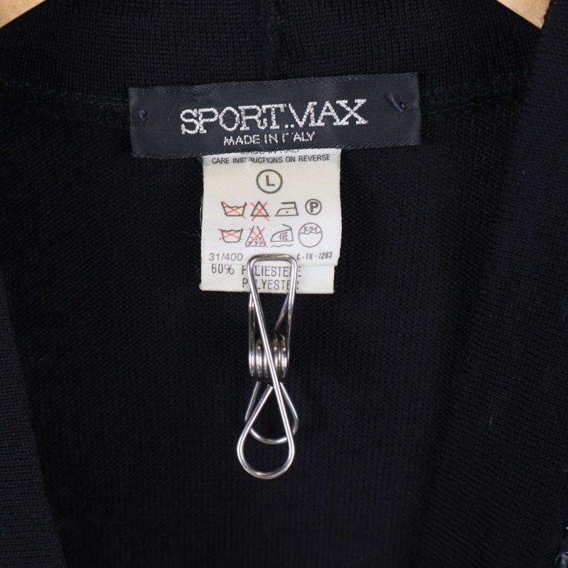 Närbild av Sportmax-etikett och tvättråd på insidan av kofta