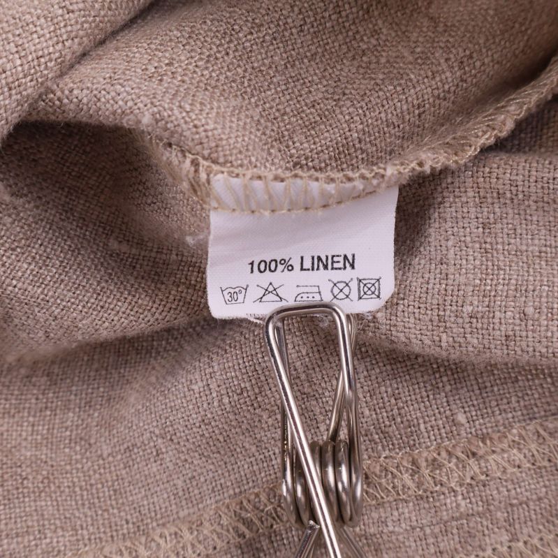 Materiallapp med texten 100% linen och tvättråd