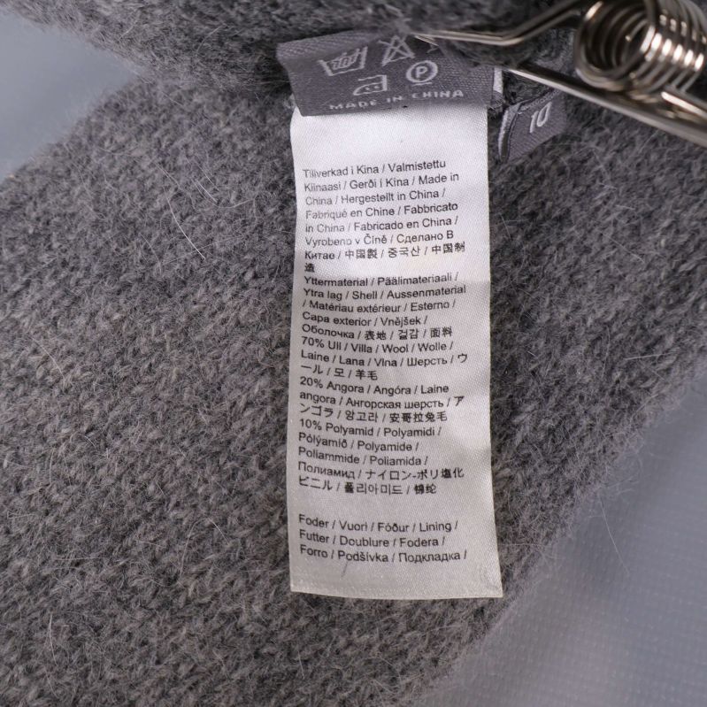 Tvättråd och tillverkningsinformation på etikett inuti tumvanten