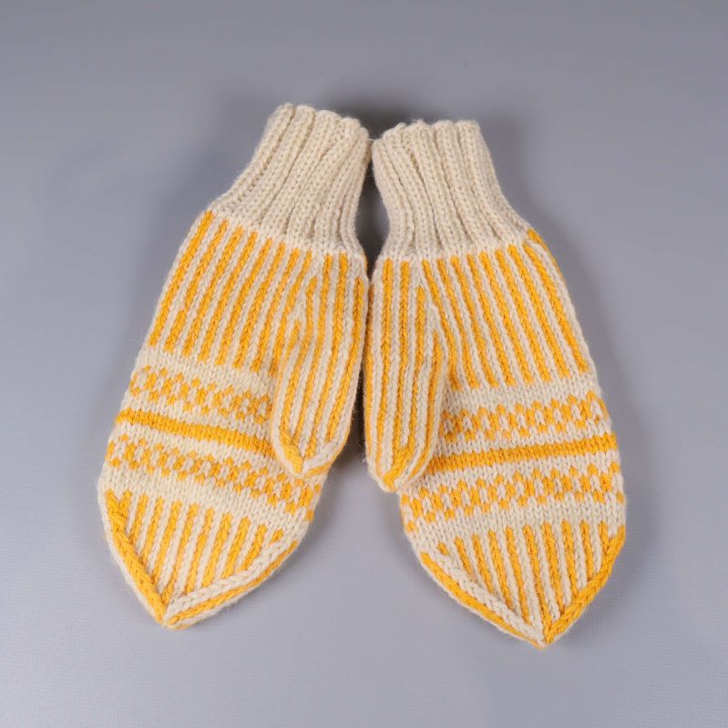 Stickade tumvantar i gult och vitt liggande platt