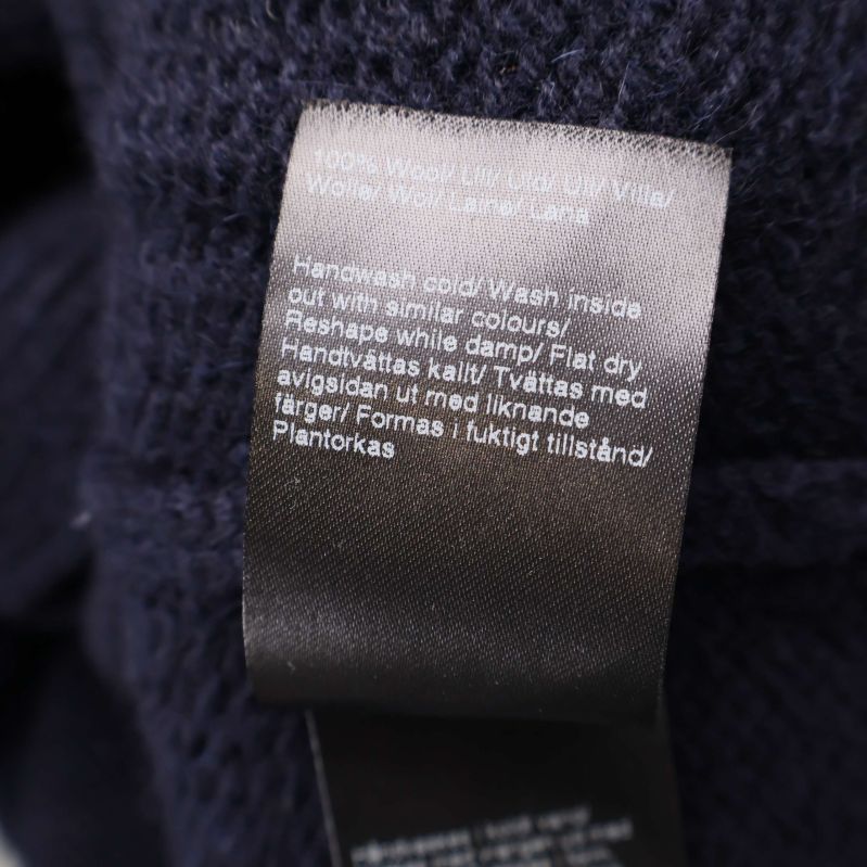 Materiallapp med information om 100% ull och tvättråd