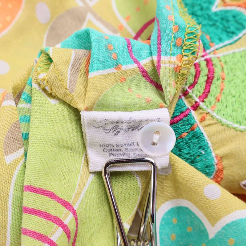 Materialetikett som visar 100% bomull