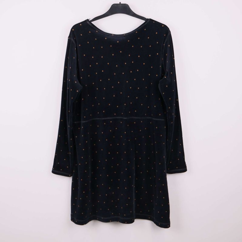 Svart klänning med små prickar bakifrån på galge